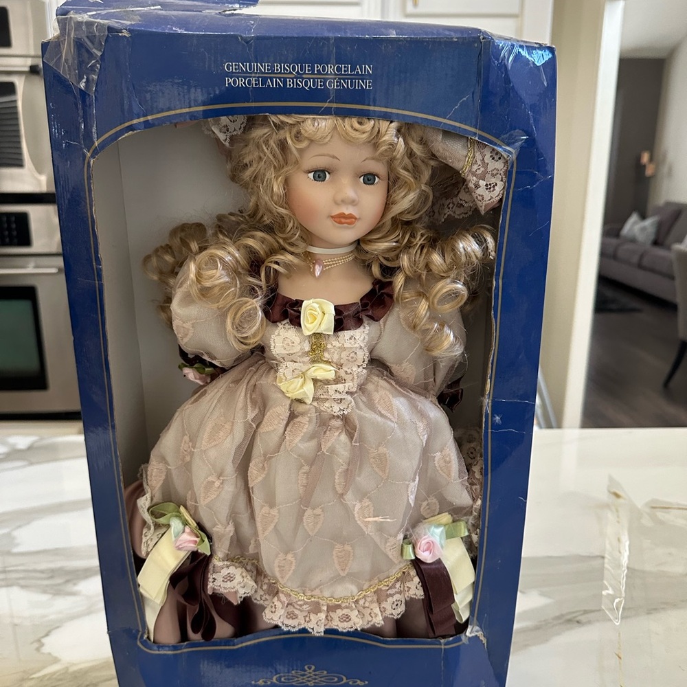 New porcelain doll in Dress new in box